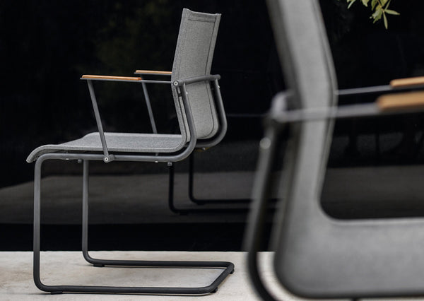 Sway stacking chair with arms